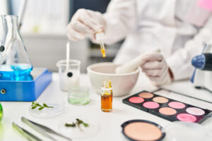 A businesswoman mixes cosmetics as she contemplates the use of Cosmetics Direct, the FDA’s new electronic cosmetics portal for facility registration and product listings in SPL format under MoCRA.