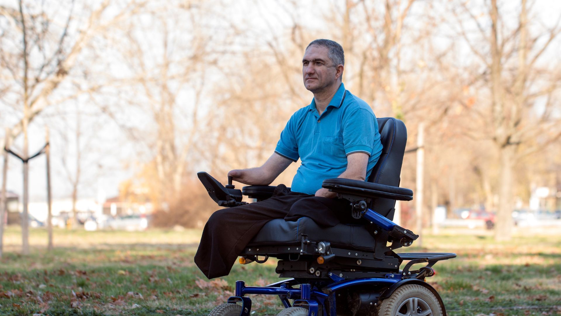 A man sits in a powered wheelchair, a Class II medical device.