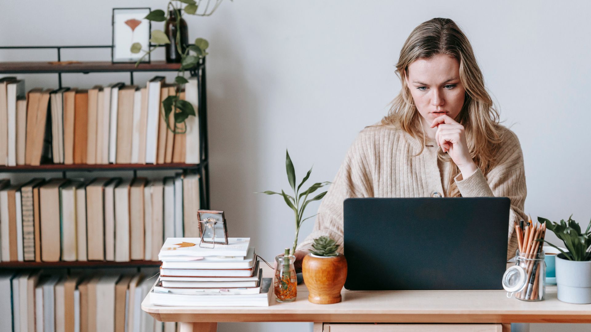 A woman on her laptop studies how she can be an SQF Practitioner even though she's new to food safety.