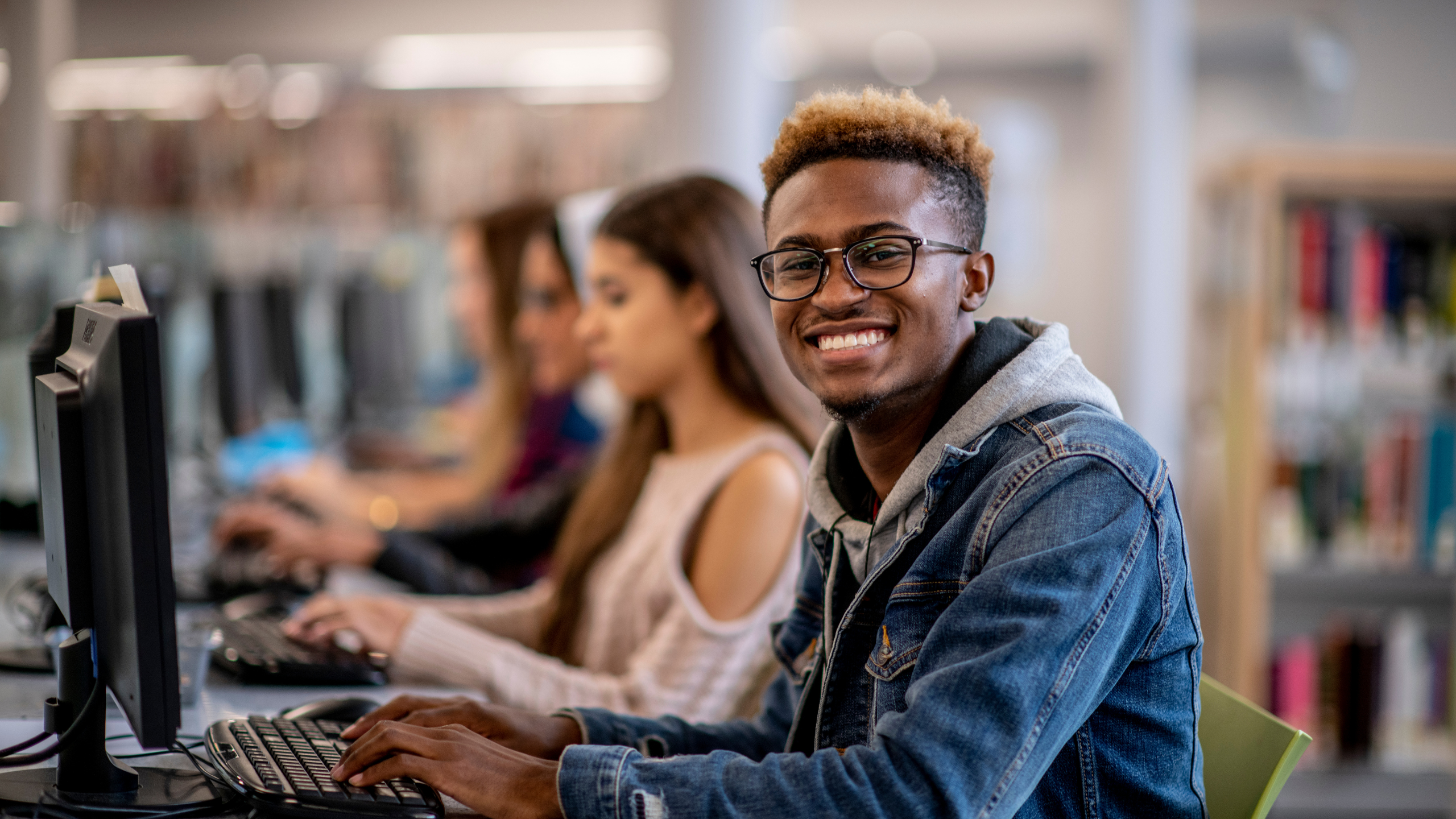 A young man at an internet cafe researches the difference between a PCQI certificate and PCQI certification.